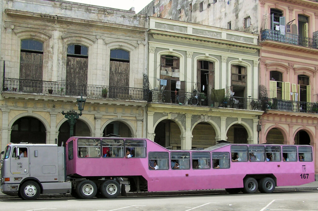 a pink bus on the street, camello habanero